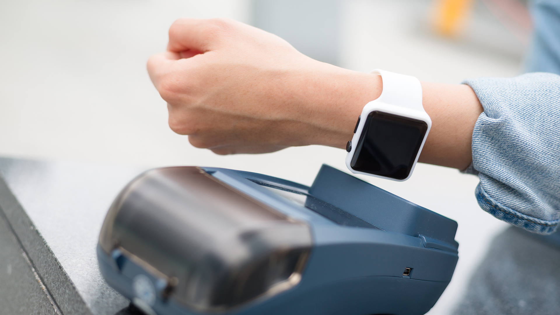 person using apple watch tap to pay