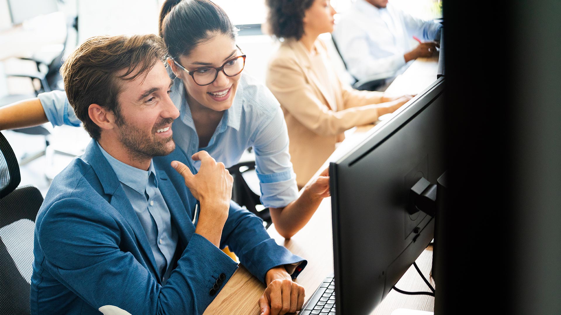 Two colleagues collaborate at the office