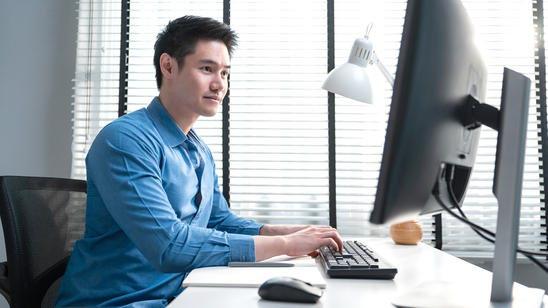 man typing on computer