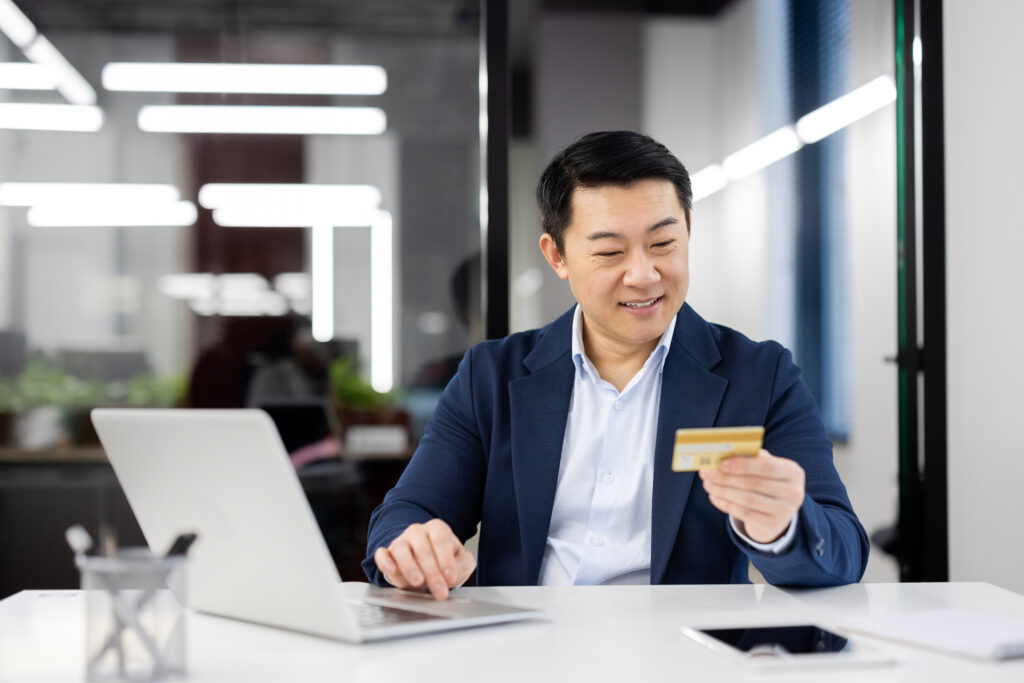 asian businessman shopping online with credit card