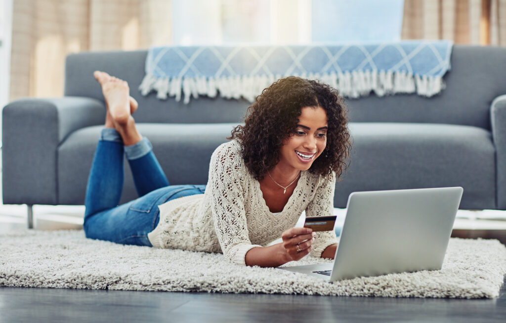 Young African woman shops online from home