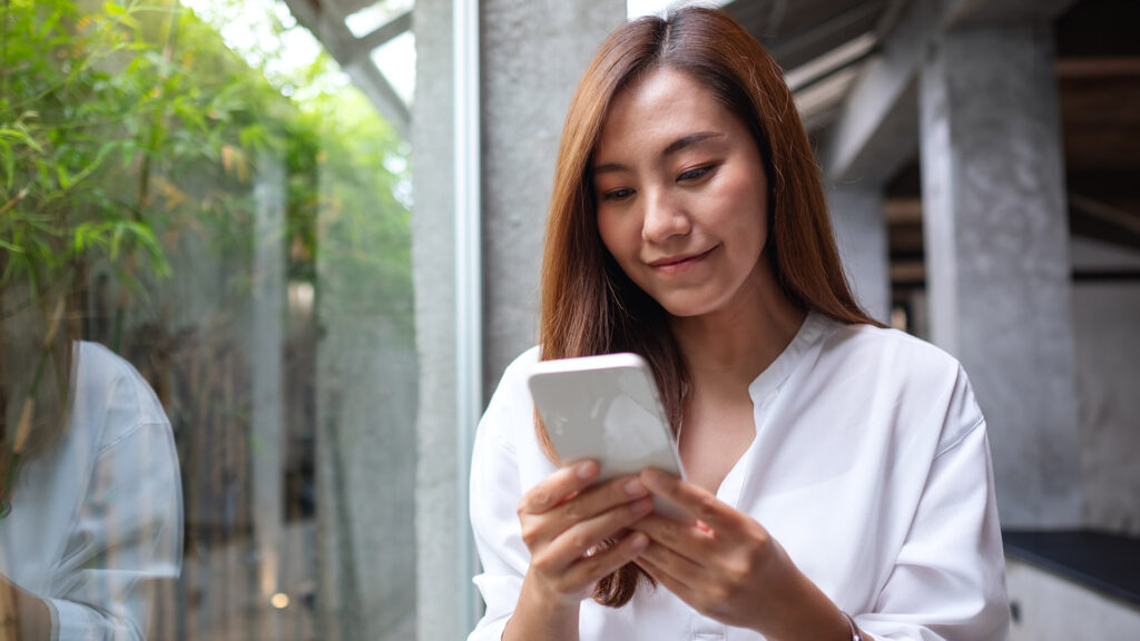 Asian woman makes mobile bill payment