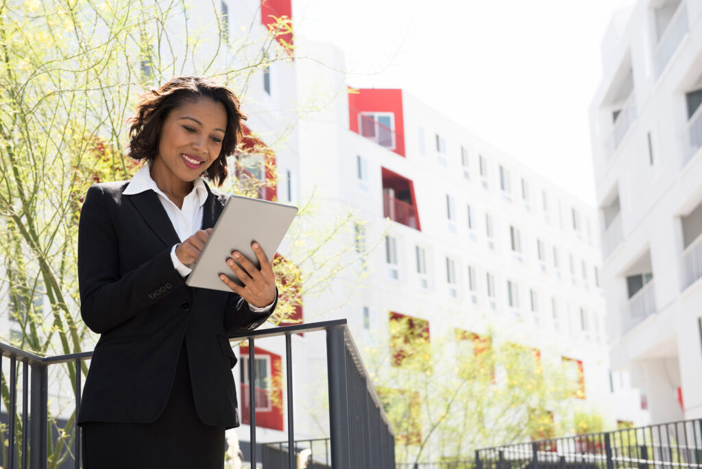 businesswoman using digital tablet outdoors