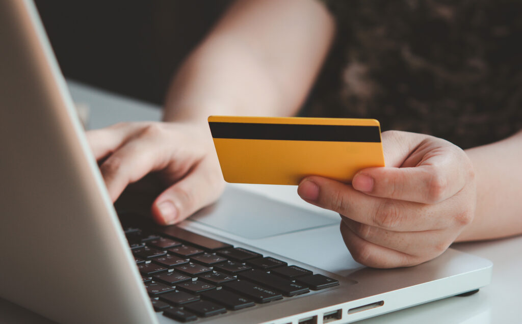 Woman makes credit card payment using laptop