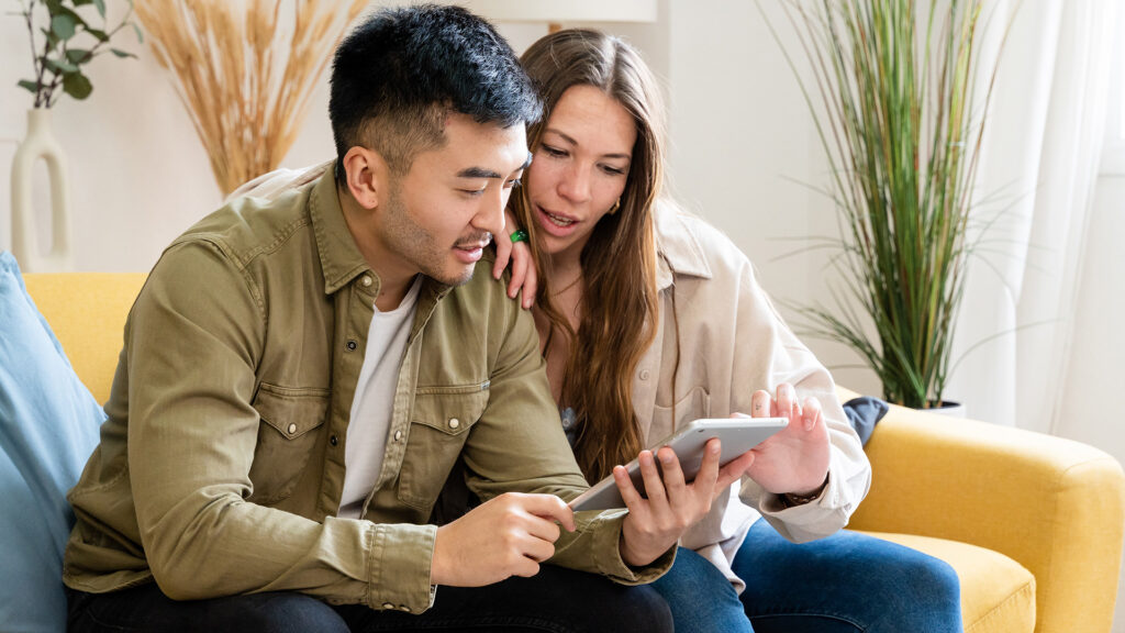 Diverse friends shop together using tablet