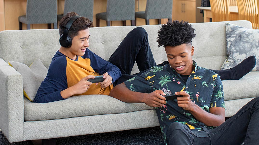 Friends in living room playing video games
