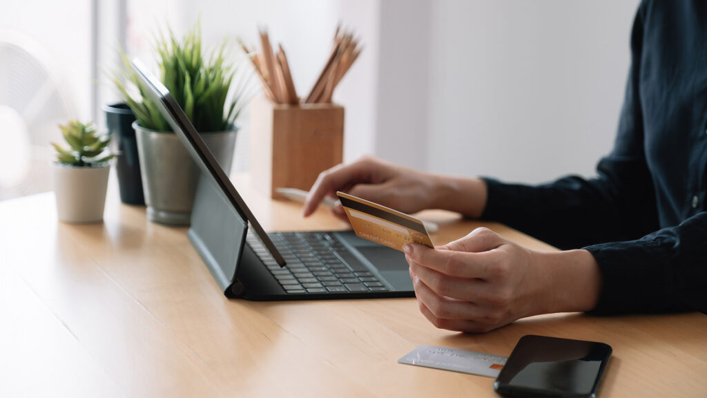 Close up of woman making payment on tablet