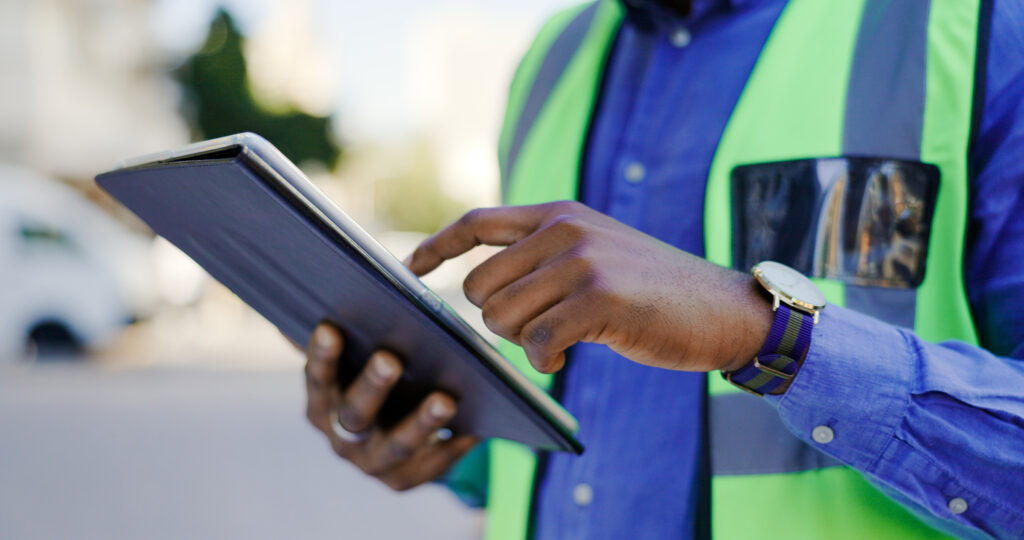 Tablet of black man or construction worker hands for engineering update, project review or progress