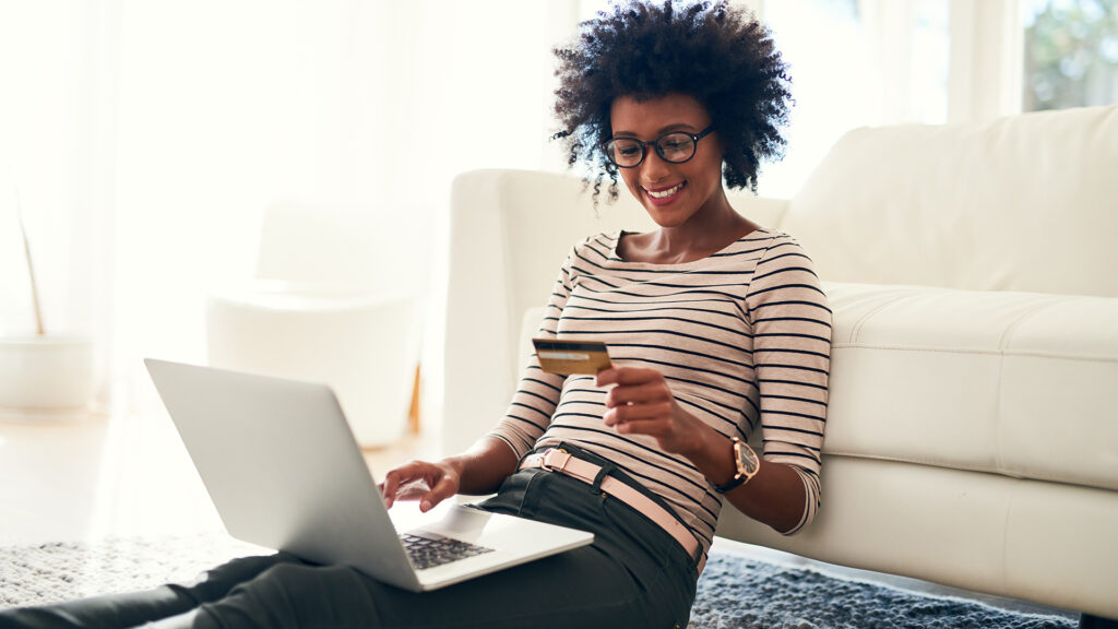 Woman at home makes payment on laptop